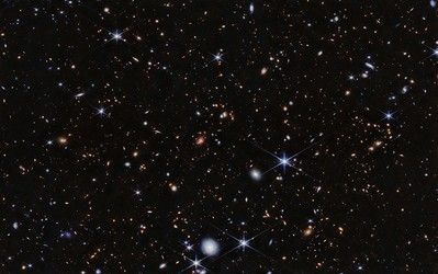 Image of deep space showing a dense field of distant galaxies, stars, and cosmic structures captured by the James Webb Space Telescope.
